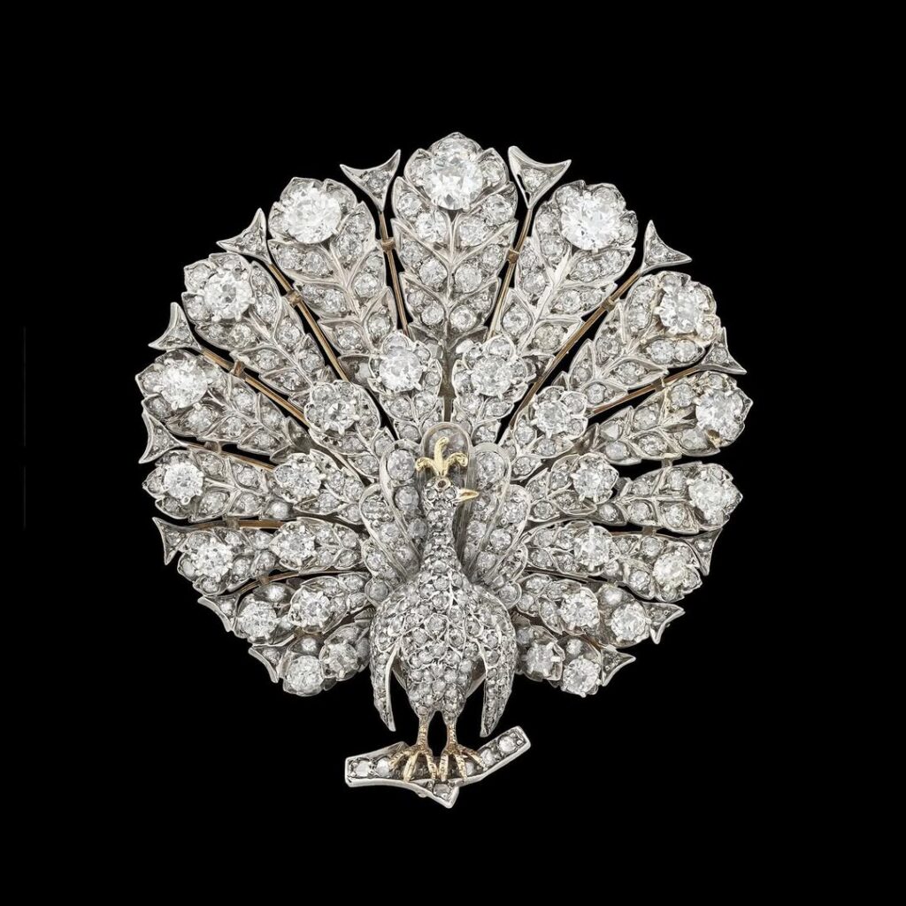 An important Victorian diamond peacock brooch-pendant, set with approximately 14 carats of diamonds mounted in silver to yellow gold back, with gold detachable pendant and brooch fittings, circa 1880.